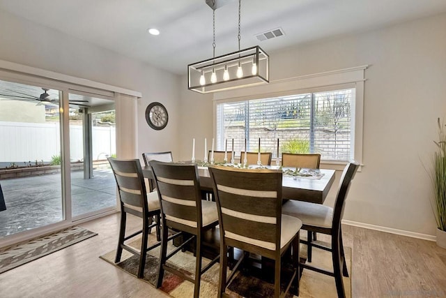 dining space featuring ceiling fan and light wood-type flooring