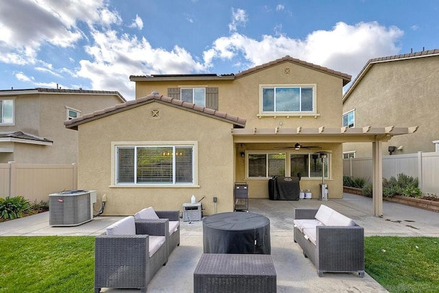 back of house featuring ceiling fan, an outdoor living space, a patio area, and central air condition unit