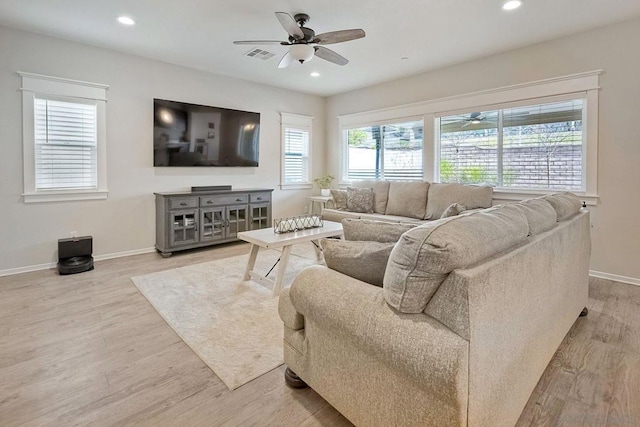 living room with light hardwood / wood-style floors and ceiling fan