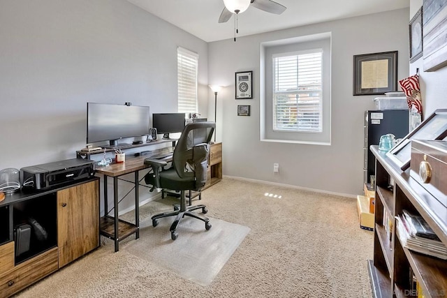 carpeted office space featuring ceiling fan