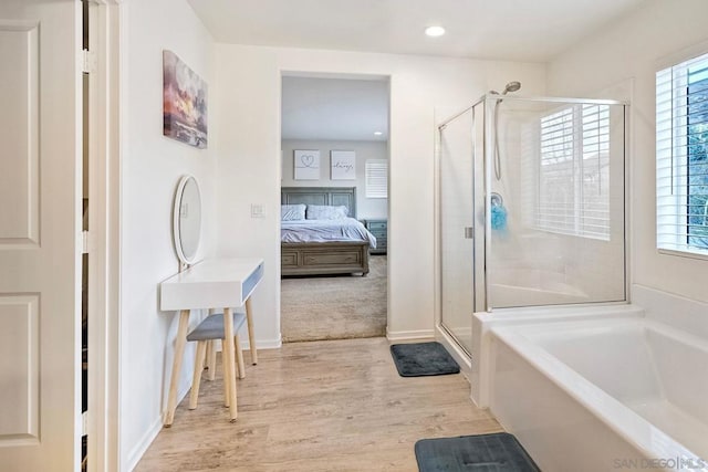 bathroom featuring wood-type flooring and plus walk in shower