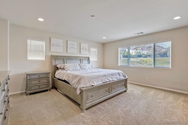 carpeted bedroom featuring multiple windows