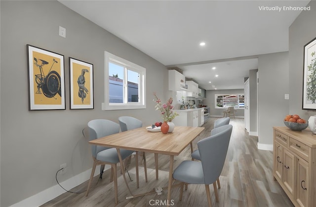 dining area featuring a healthy amount of sunlight and light wood-type flooring