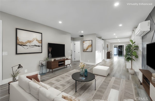 living room featuring an AC wall unit and light wood-type flooring