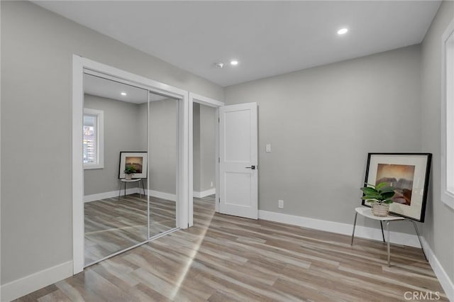 unfurnished bedroom featuring a closet and light wood-type flooring