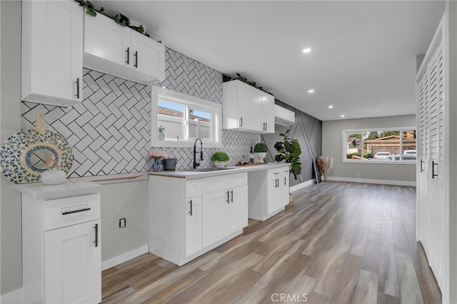 kitchen featuring white cabinetry, sink, and a wealth of natural light