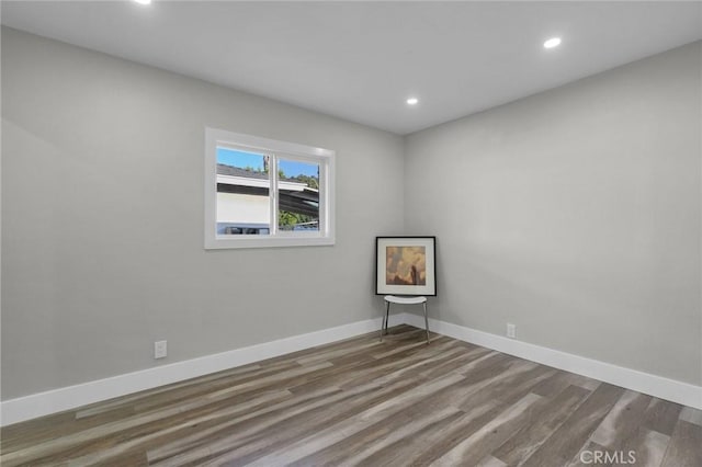 unfurnished room with wood-type flooring