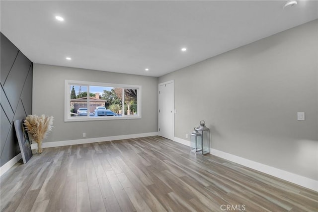 empty room with light hardwood / wood-style flooring