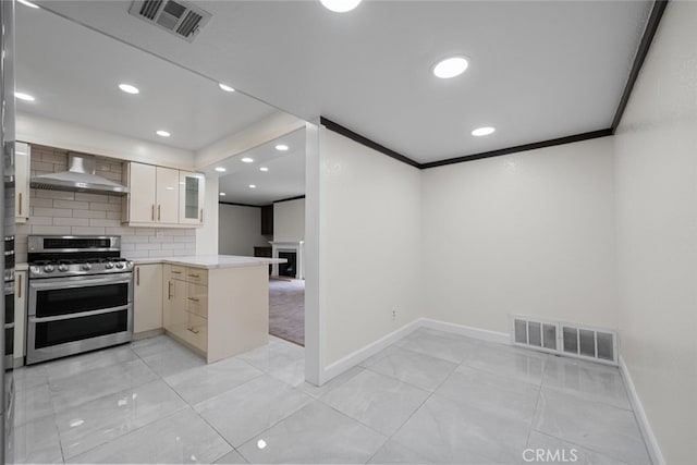 kitchen with wall chimney exhaust hood, double oven range, crown molding, and kitchen peninsula