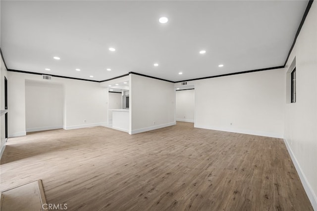 unfurnished living room with crown molding and light hardwood / wood-style flooring