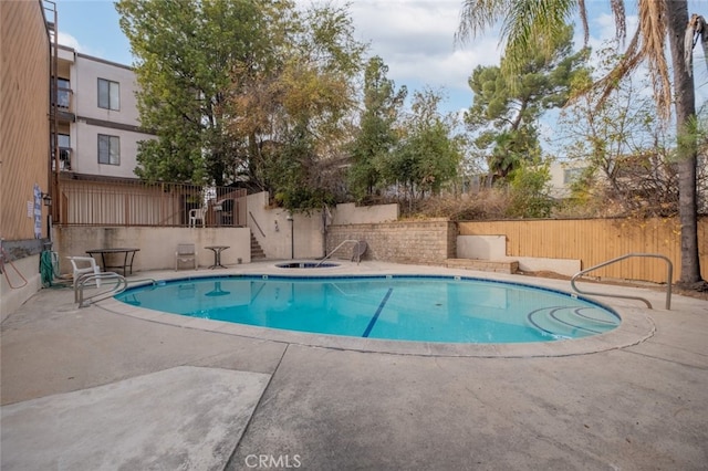 view of swimming pool with a patio area