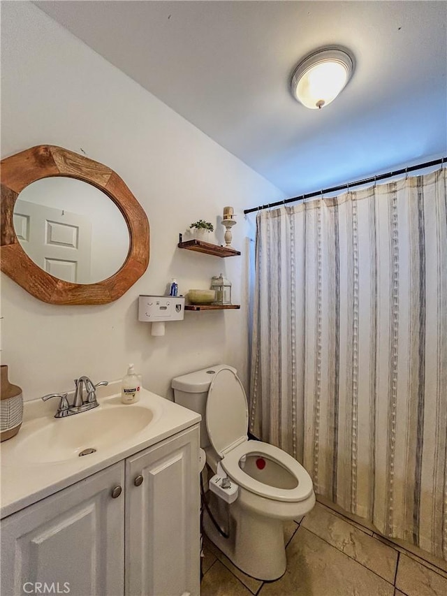 bathroom featuring a shower with curtain, vanity, tile patterned floors, and toilet