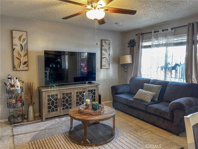 living room with ceiling fan and a textured ceiling