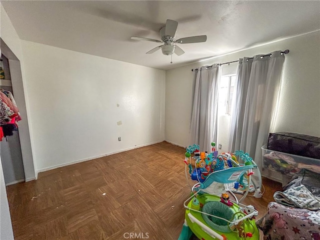 recreation room with parquet floors and ceiling fan