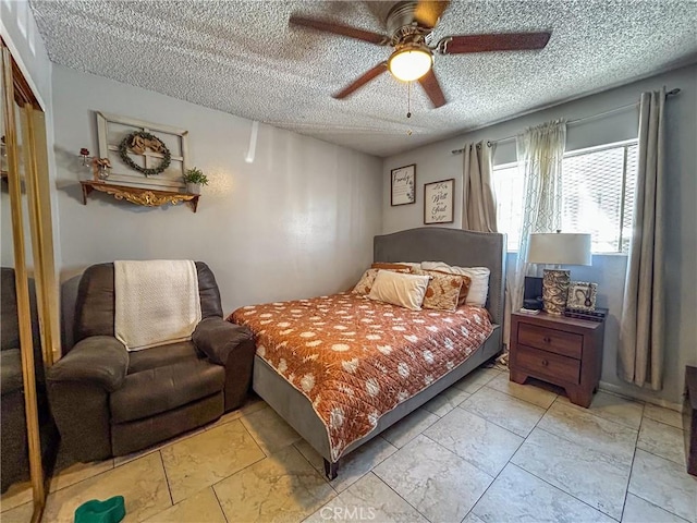 bedroom featuring ceiling fan, a textured ceiling, and a closet