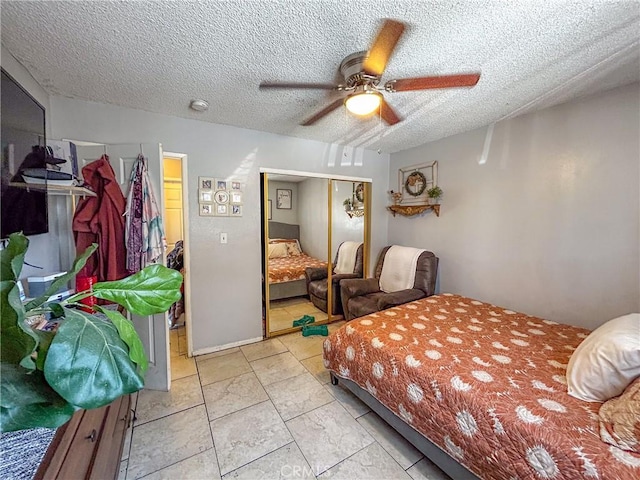 bedroom with ceiling fan, a closet, and a textured ceiling