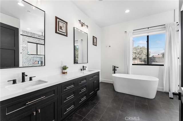 bathroom featuring vanity, tile patterned floors, and a bathtub