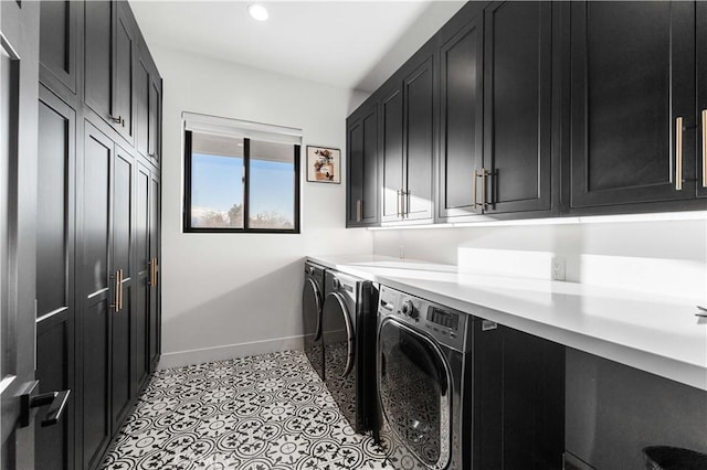 clothes washing area featuring cabinets, independent washer and dryer, and light tile patterned flooring