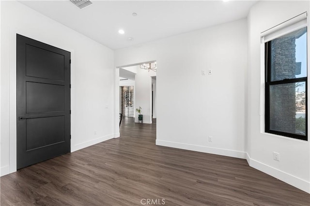 empty room with dark hardwood / wood-style floors