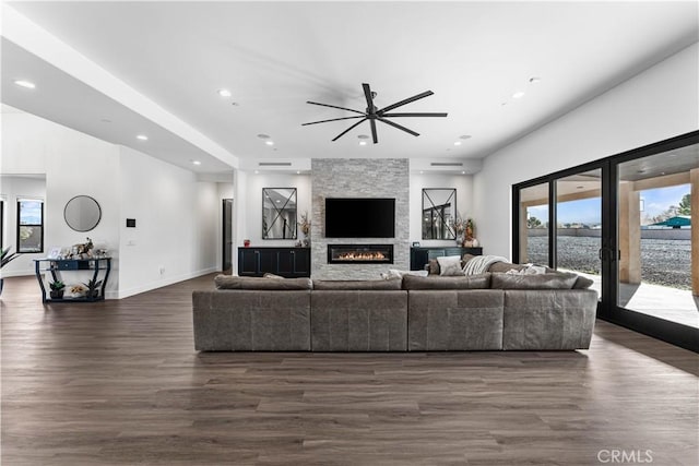 living room with dark wood-type flooring and a fireplace