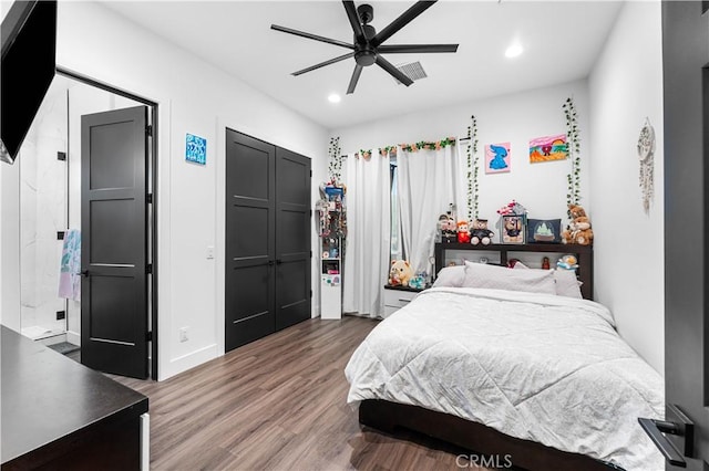 bedroom featuring hardwood / wood-style flooring, a closet, and ceiling fan