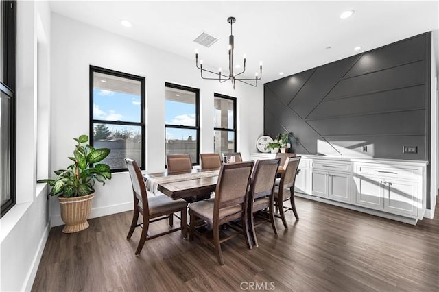 dining area featuring an inviting chandelier and dark hardwood / wood-style flooring