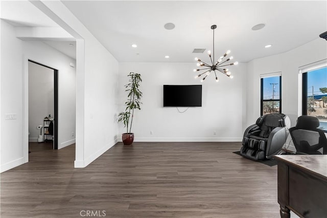 workout room with dark wood-type flooring and a chandelier