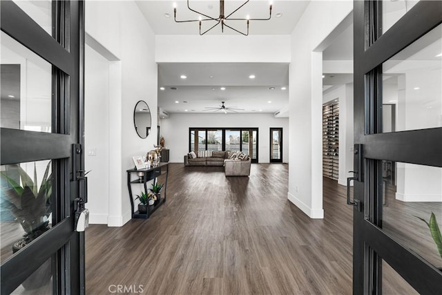 foyer entrance featuring a notable chandelier and dark hardwood / wood-style flooring