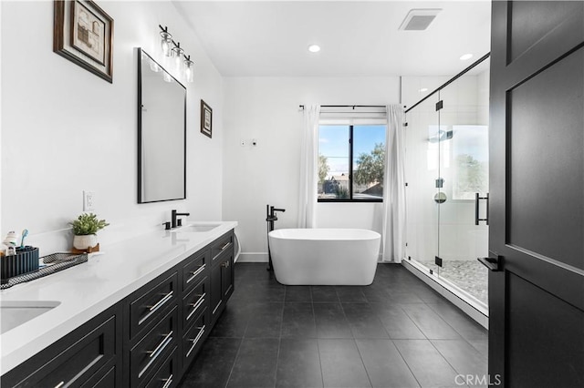 bathroom with baseboard heating, tile patterned floors, vanity, and separate shower and tub