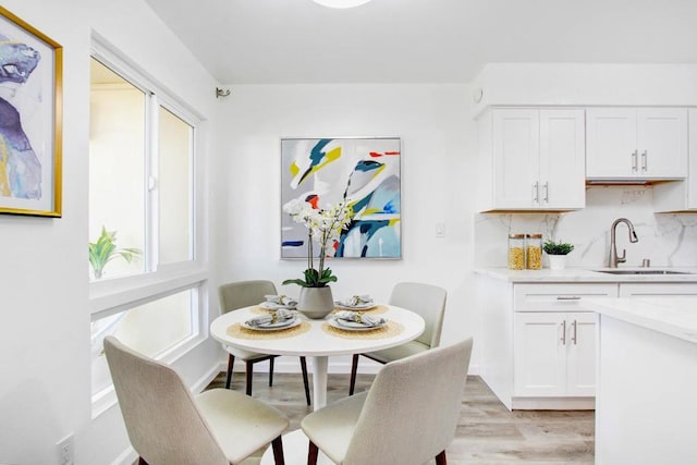 dining area featuring sink and light hardwood / wood-style flooring