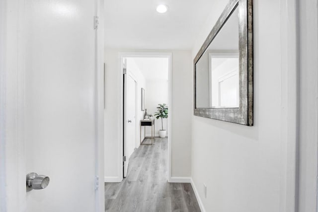 corridor with light hardwood / wood-style floors