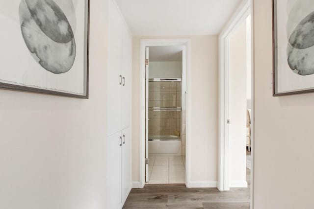 hallway with hardwood / wood-style floors