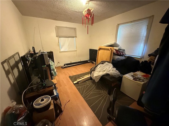 misc room featuring hardwood / wood-style floors and a textured ceiling