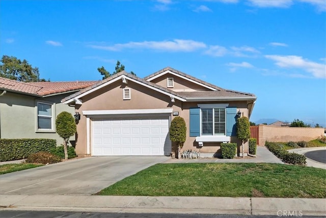 ranch-style house featuring a garage, a tiled roof, concrete driveway, and stucco siding