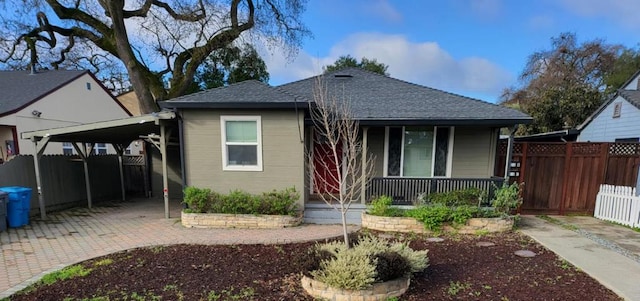 bungalow-style house featuring a carport and covered porch