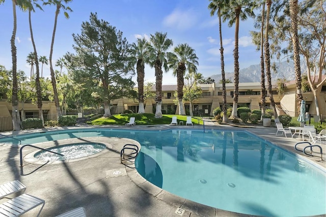 view of swimming pool with a patio area and a community hot tub