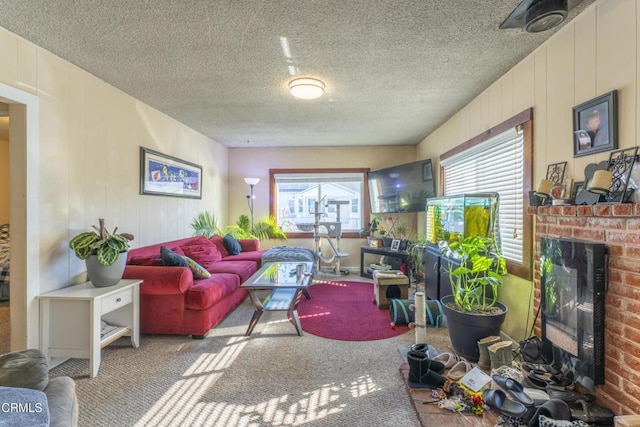 carpeted living room featuring a textured ceiling and a fireplace