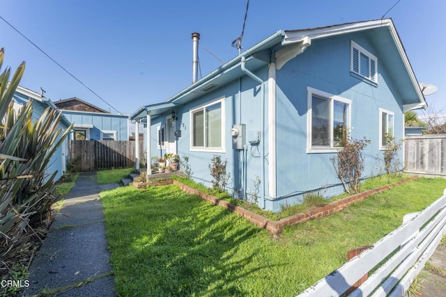 view of property exterior featuring a lawn