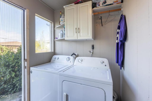 laundry room featuring cabinets and separate washer and dryer