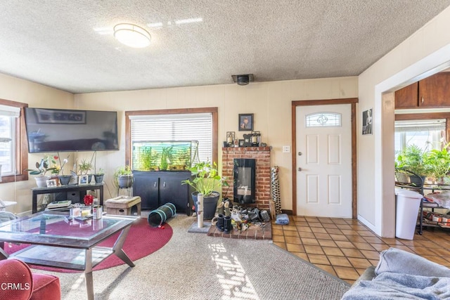 living room featuring a brick fireplace, a wealth of natural light, and tile patterned floors