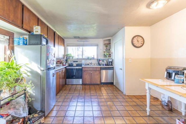 kitchen with sink, tile patterned floors, and stainless steel appliances