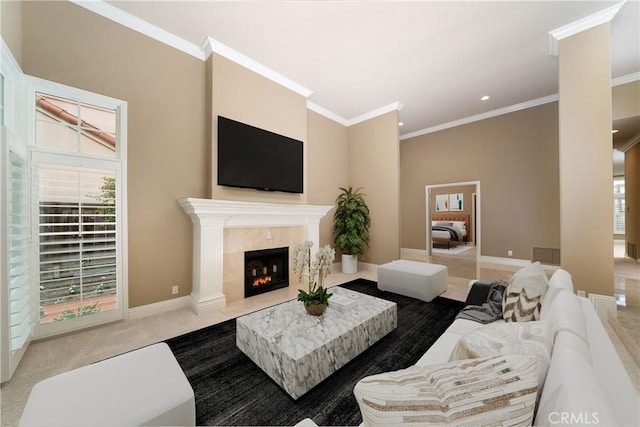 living room with a premium fireplace, carpet, and ornamental molding