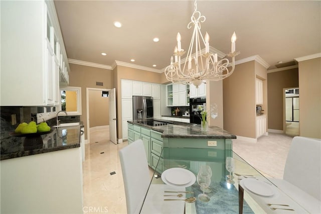 kitchen with a kitchen island, white cabinetry, dark stone countertops, hanging light fixtures, and stainless steel fridge with ice dispenser