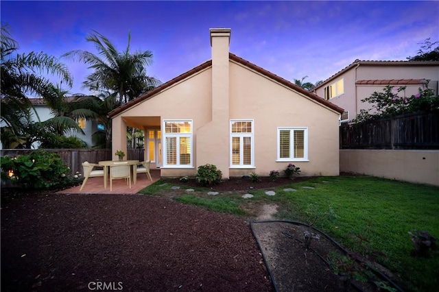 12999 Caminito Pointe Del Mar, Del Mar, CA 92014 - rear view of house with a patio, a chimney, stucco siding, a yard, and a fenced backyard