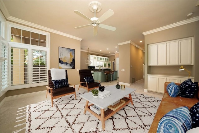 living room with light carpet, sink, crown molding, and ceiling fan