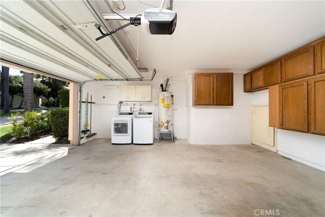 garage with a garage door opener, washing machine and dryer, and water heater