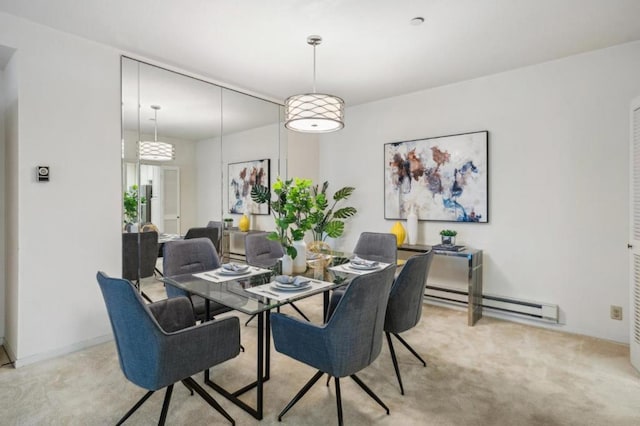 dining space featuring light carpet and baseboard heating