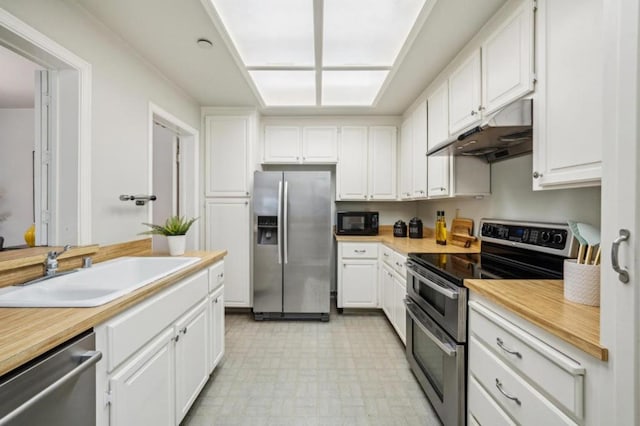 kitchen featuring stainless steel appliances, sink, and white cabinets