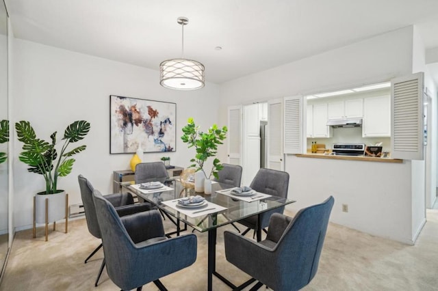 dining space with light carpet and baseboard heating