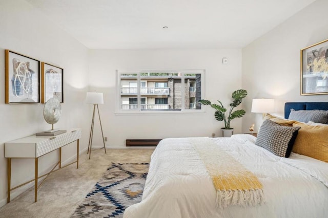 carpeted bedroom with a baseboard heating unit